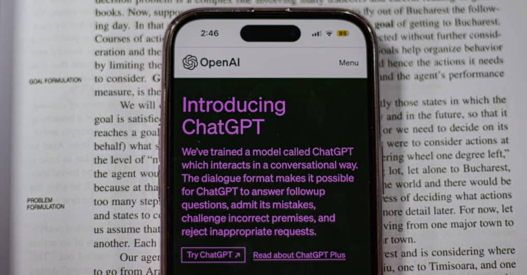 ChatGPT displayed on mobile on a book